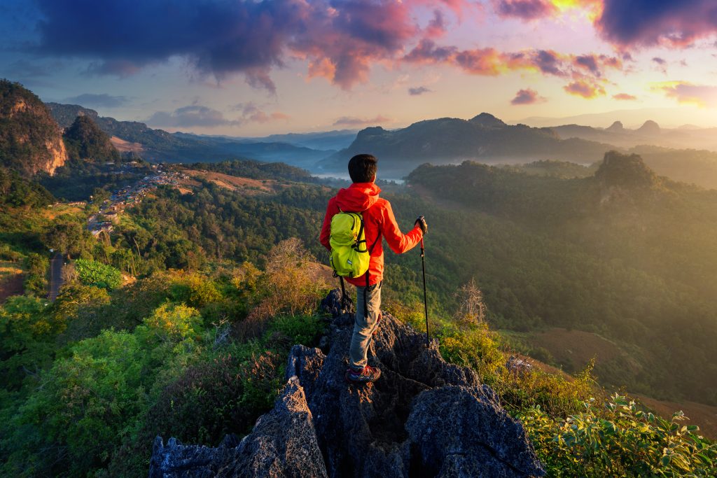 backpacker standing on sunrise viewpoint at ja bo village, mae h
